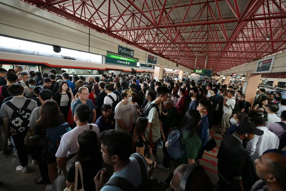 Commuters wait on platform F for shuttle train to Boon Lay on Sept 30.  
