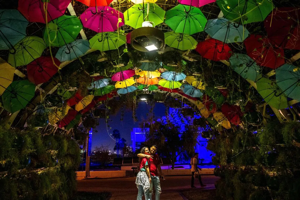 A couple visit at the Al Masrah Park in Doha Doha on November 29, 2022, during the Qatar 2022 World Cup football tournament. 