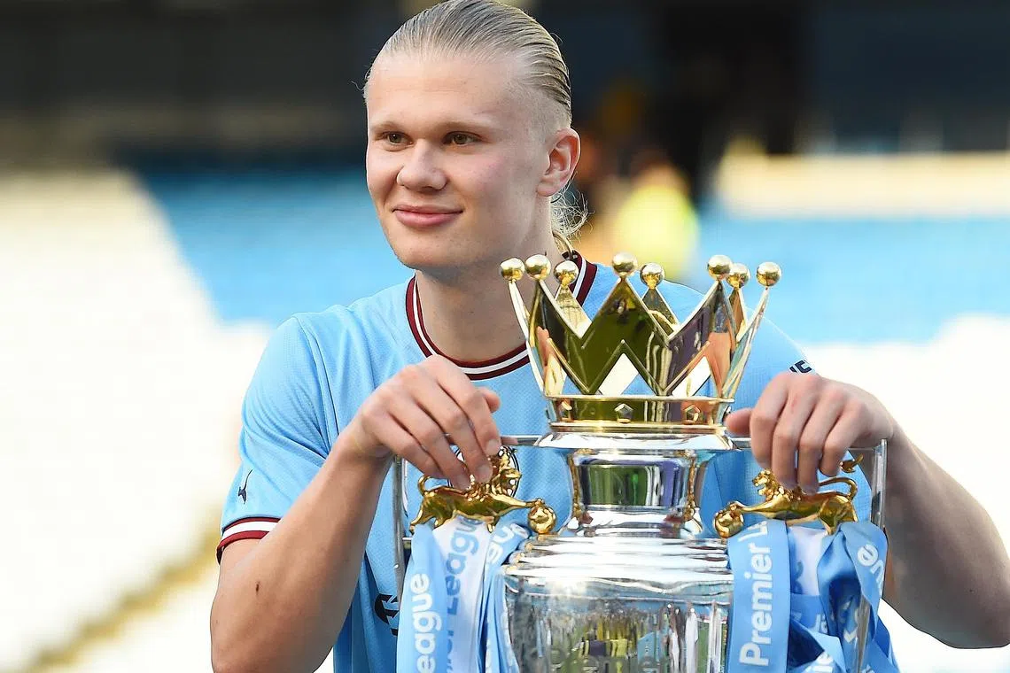 Erling Haaland posing with the English Premier League trophy, after Manchester City were crowned champions on Sunday. The Norwegian hitman played a crucial role in his side's title triumph, as he scored a record-breaking 36 goals with two matches yet to be played.