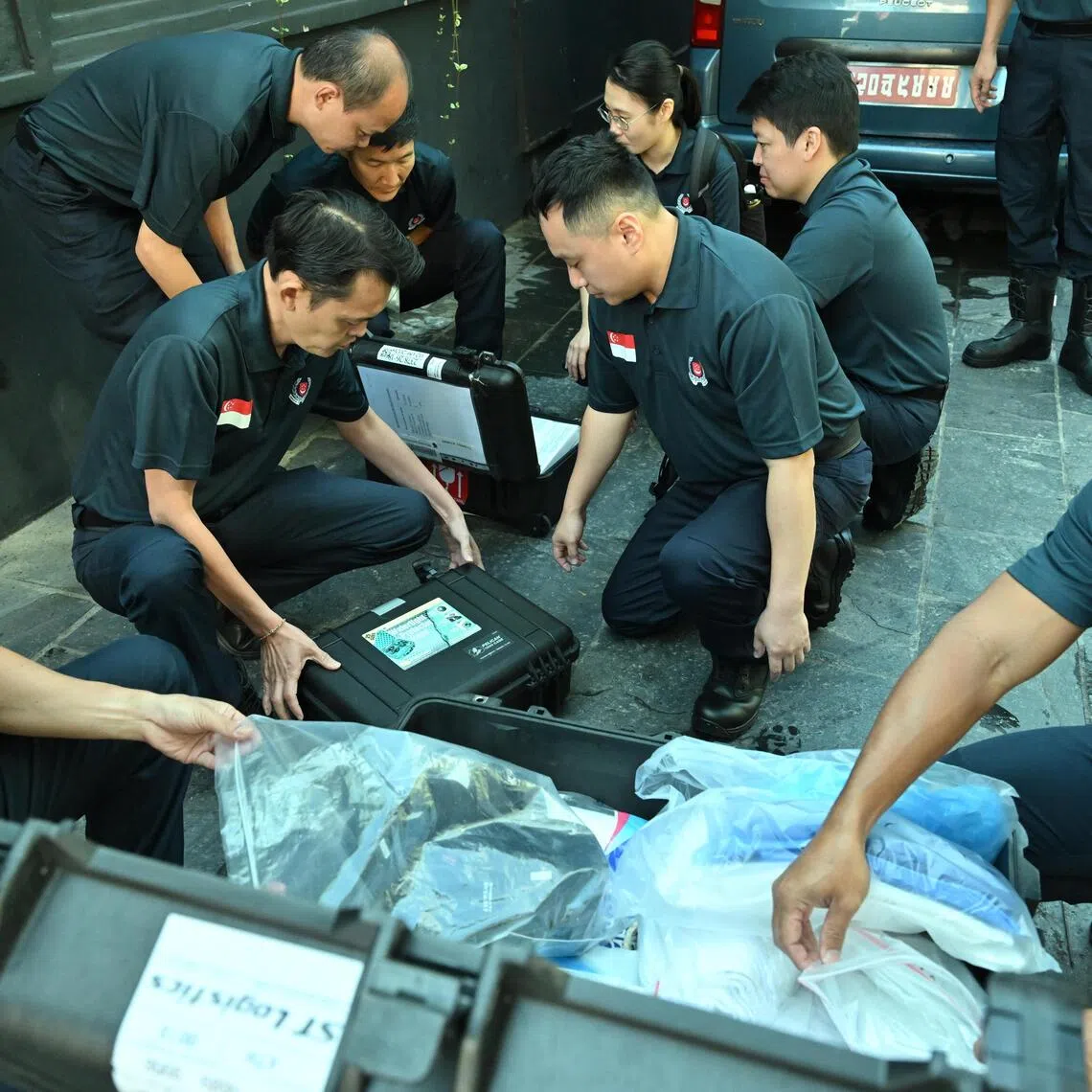 Singapore Police Force officers checking and inspecting their equipment before setting off from their base in Kathmandu, Nepal on Sept 5.