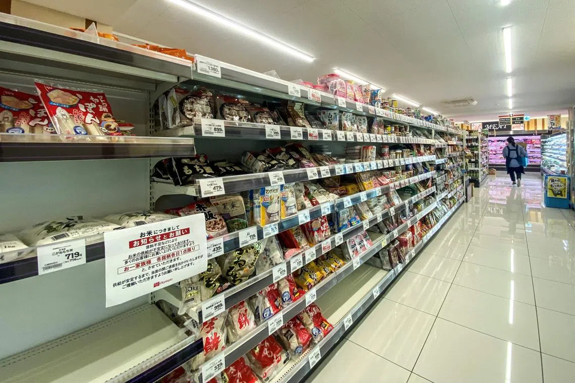 Empty shelves of rice are pictured in a supermarket with a notice written: "Due to shortage of resource materials, supply of rice has been unstable. So as for many customers to be able to buy, we ask you to buy one brand a day for a family. We beg you for your understanding for causing troubles for a while until supply stabilises." at the neighbourhood of Morishita in Koto district of Tokyo on August 27, 2024