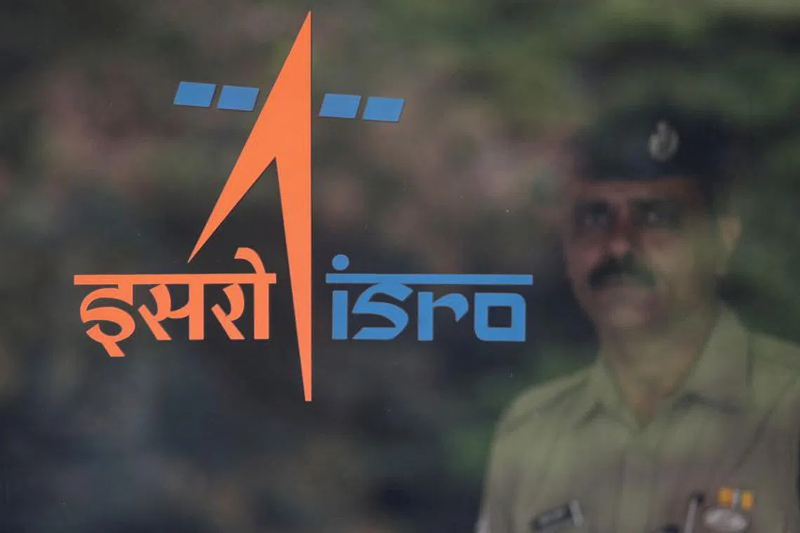FILE PHOTO: A security guard stands behind the logo of Indian Space Research Organisation (ISRO) at its headquarters in Bengaluru, India, June 12, 2019. REUTERS/Francis Mascarenhas/File photo