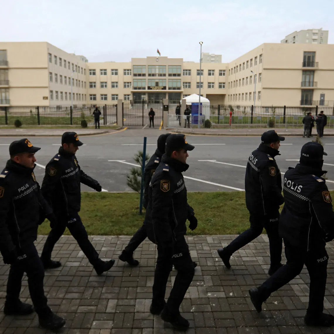 Police officers walk outside a courthouse on the day of the trial of former political figures and officials of the breakaway region of Nagorno-Karabakh, accused of various charges, including genocide and war crimes, in Baku, Azerbaijan January 17, 2025. REUTERS/Aziz Karimov
