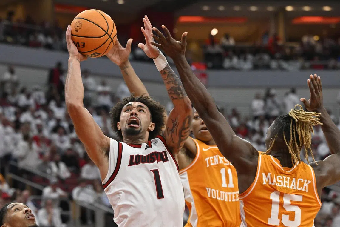Nov 9, 2024; Louisville, Kentucky, USA;  Louisville Cardinals guard J'Vonne Hadley (1) shoots against Tennessee Volunteers guard Jordan Gainey (11) and guard Jahmai Mashack (15) during the second half at KFC Yum! Center. Tennessee defeated Louisville 77-55. Mandatory Credit: Jamie Rhodes-Imagn Images/ File Photo