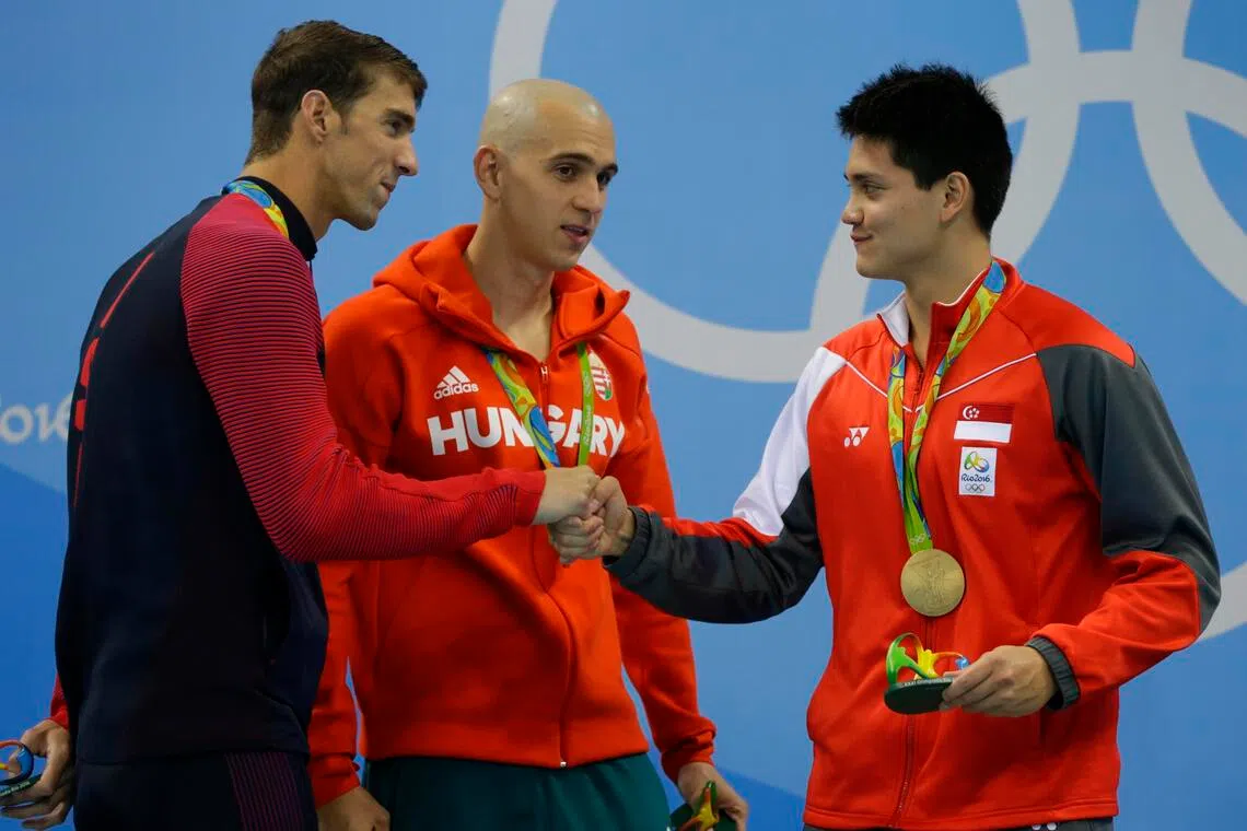 Michael Phelps (left) of US congratulating Joseph Schooling (right) of Singapore, as Hungary’s Laszlo Cseh looks on, at the Olympic Aquatics Stadium in Rio de Janeiro, on Aug 12, 2016.