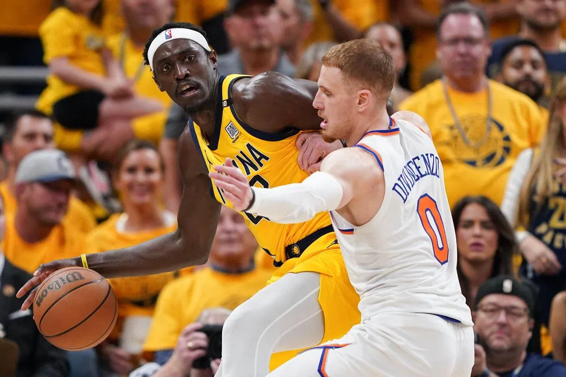 Pascal Siakam of the Indiana Pacers dribbles the ball against Donte DiVincenzo of the New York Knicks during the second quarter in Game 6 of the NBA Eastern Conference semi-finals.