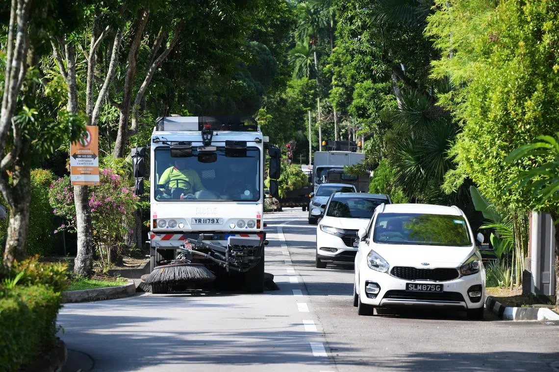 A road sweeping vehicles ploughs Jalan Wajek, a roughly 300m-long road in the Jalan Wajek estate in Bukit Timah, as part of the National Environment Agency's Alternate Roadside Parking programme, which was launched in 2019.