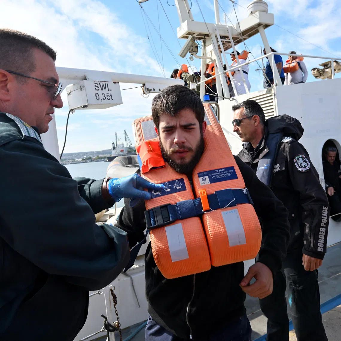 Crew members from a ship damaged in a drone attack disembark from a Bulgarian border police vessel in Varna, Bulgaria, following a rescue operation after one vessel was sunk and another damaged in the Black Sea off Bulgaria, October 6, 2026. REUTERS/Petko Momchilov
