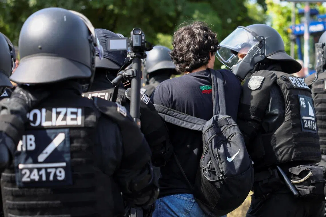 Police detain a protester as Germany's far-right Alternative for Germany (AfD) holds a party convention in Essen, on June 29.