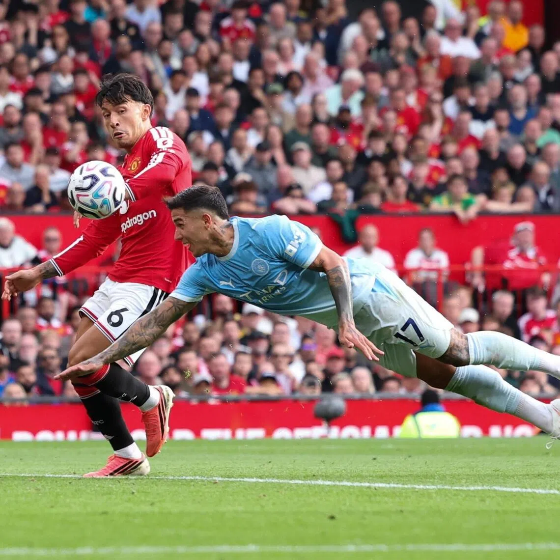 Manchester City’s Enzo Fernandez dives for the ball as Manchester United’s Lisandro Martinez defends, immediately before Erling Haaland scored City’s winner in their English Premier League game on Sept 13. The VAR failed to spot that Fernandez was clearly offside and interfering with play.