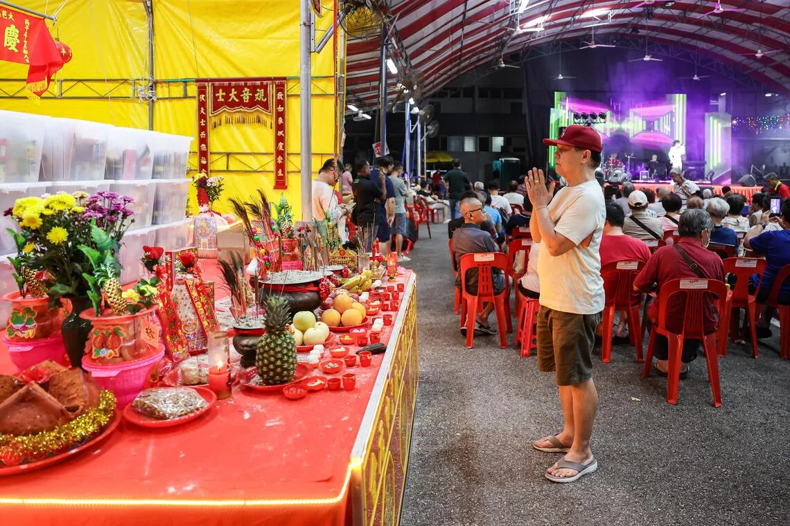A member of the audience praying at a Hungry Ghost Festival getai show at Toa Payoh Industrial Park on Aug 20.