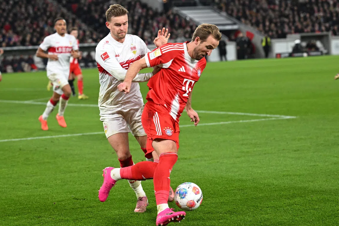 Soccer Football - Bundesliga - VfB Stuttgart v Bayern Munich - MHPArena, Stuttgart, Germany - December 6, 2025 Bayern Munich's Harry Kane in action with VfB Stuttgart's Maximilian Mittelstadt REUTERS/Angelika Warmuth