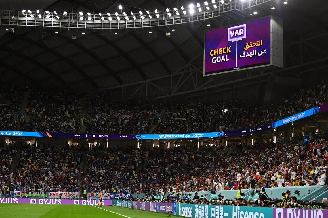 A goal decision by the video assistant referee (VAR) system is announced on a huge screen during the FIFA World Cup 2022 round of 16 soccer match between Japan and Croatia.