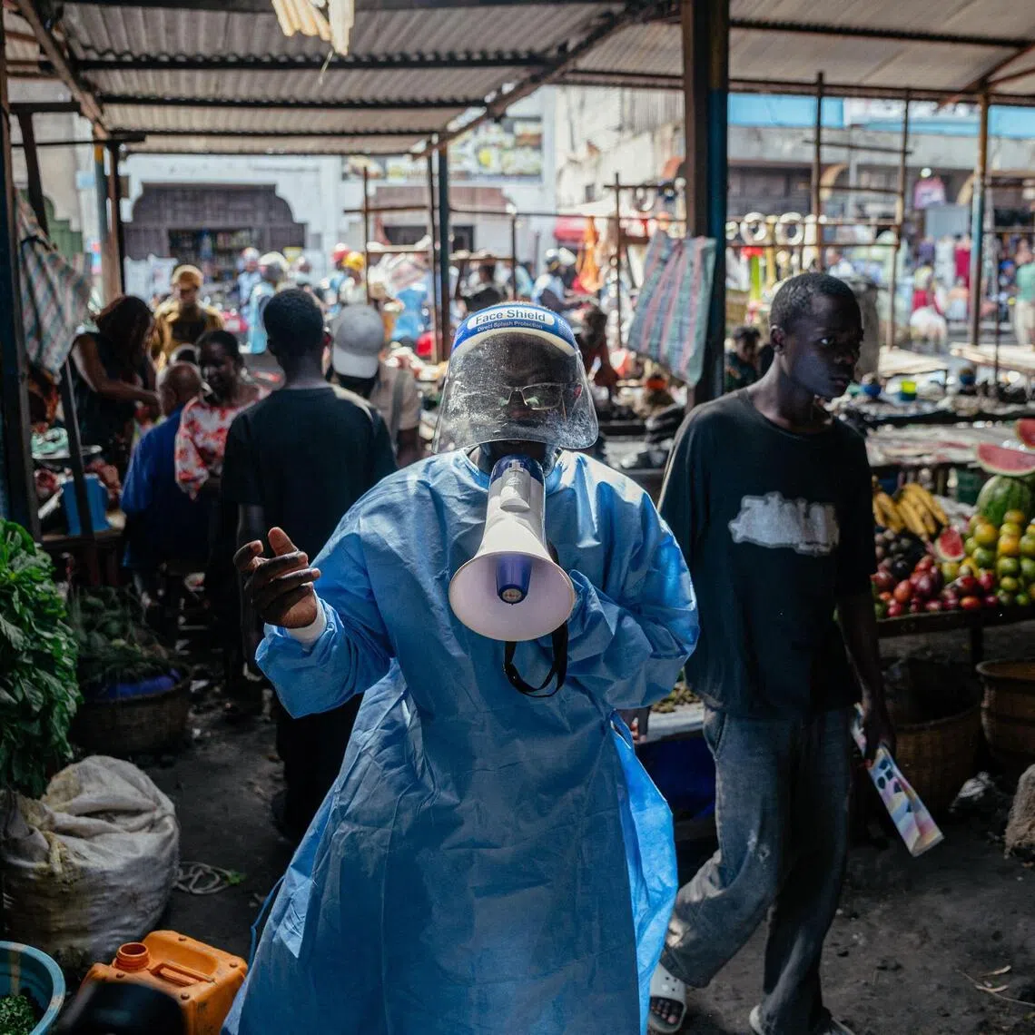 Irenge Biringanine Prince, a community leader is dressed in protective equipment as she raises awareness among traders at the Alanine market about Ebola prevention and awareness measures in Goma, on May 29, 2026. 