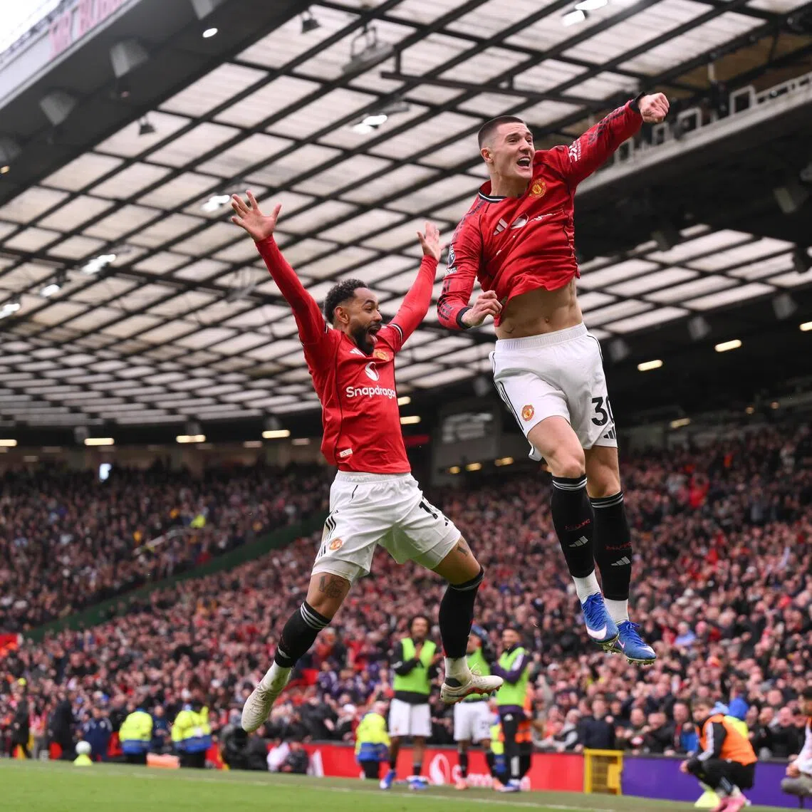 Benjamin Sesko (right) of Manchester United celebrates scoring the third goal of their 3-1 English Premier League win over Aston Villa with Bruno Fernandes on March 15.