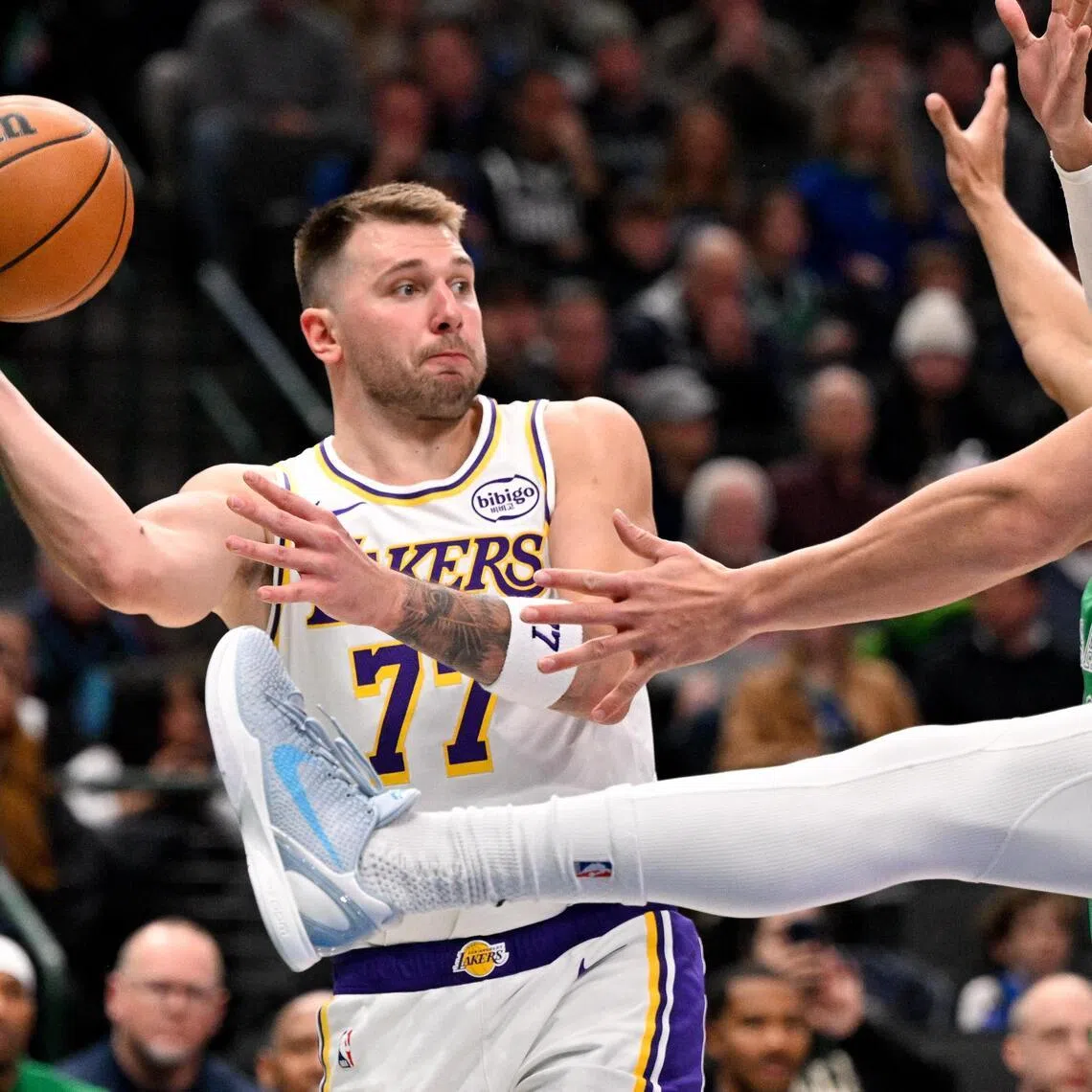 Los Angeles Lakers guard Luka Doncic looking to pass the ball past Dallas Mavericks forward Dwight Powell during the second half of the Lakers' NBA 116-110 win at the American Airlines Center on Jan 24, 2026.