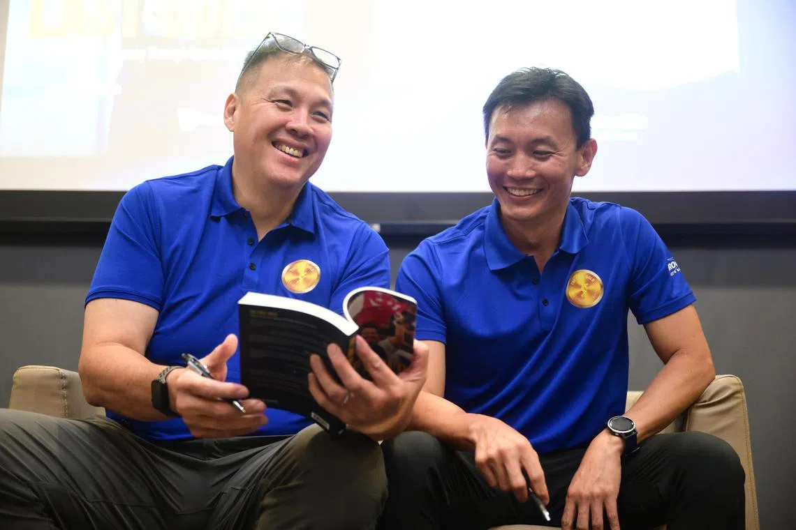 Singapore's discus king James Wong (left) officially launched his book titled ‘The Last Gold', which was written by former national sprinter Kenneth Khoo (right).