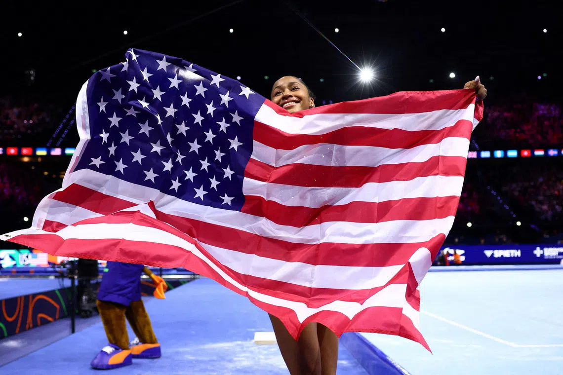 American gymnast Skye Blakely celebrates winning the women’s all around world title.