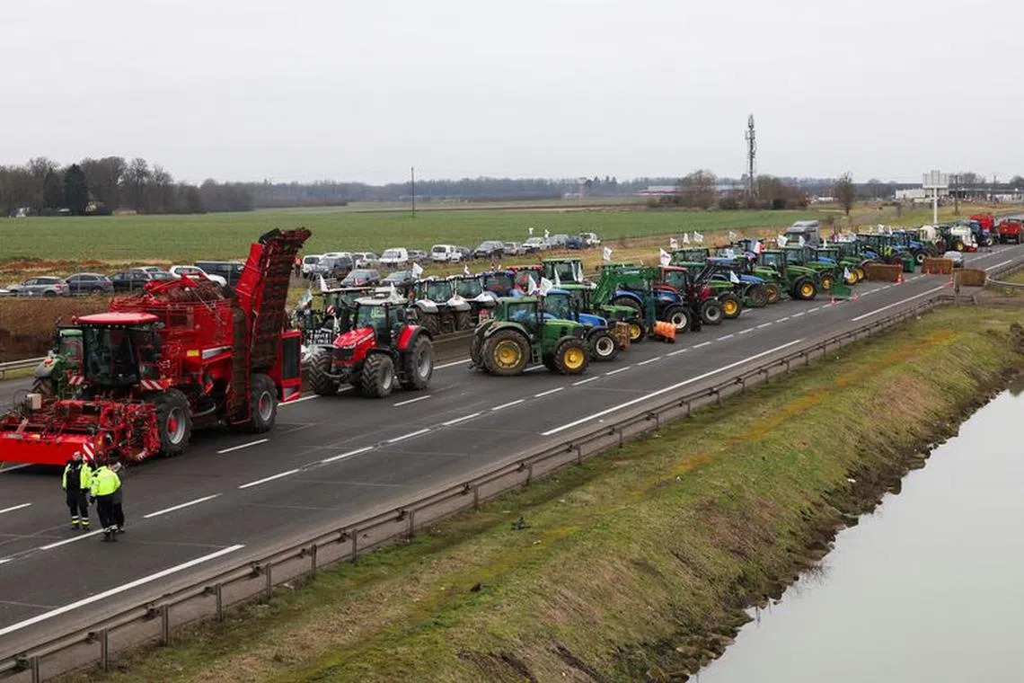 Vehicles are lined up during a blockade by farmers on the A4 highway to protest over price pressures, taxes and green regulation, grievances that are shared by farmers across Europe, in Jossigny, near Paris, France, January 30, 2024. REUTERS/Yves Herman/File Photo