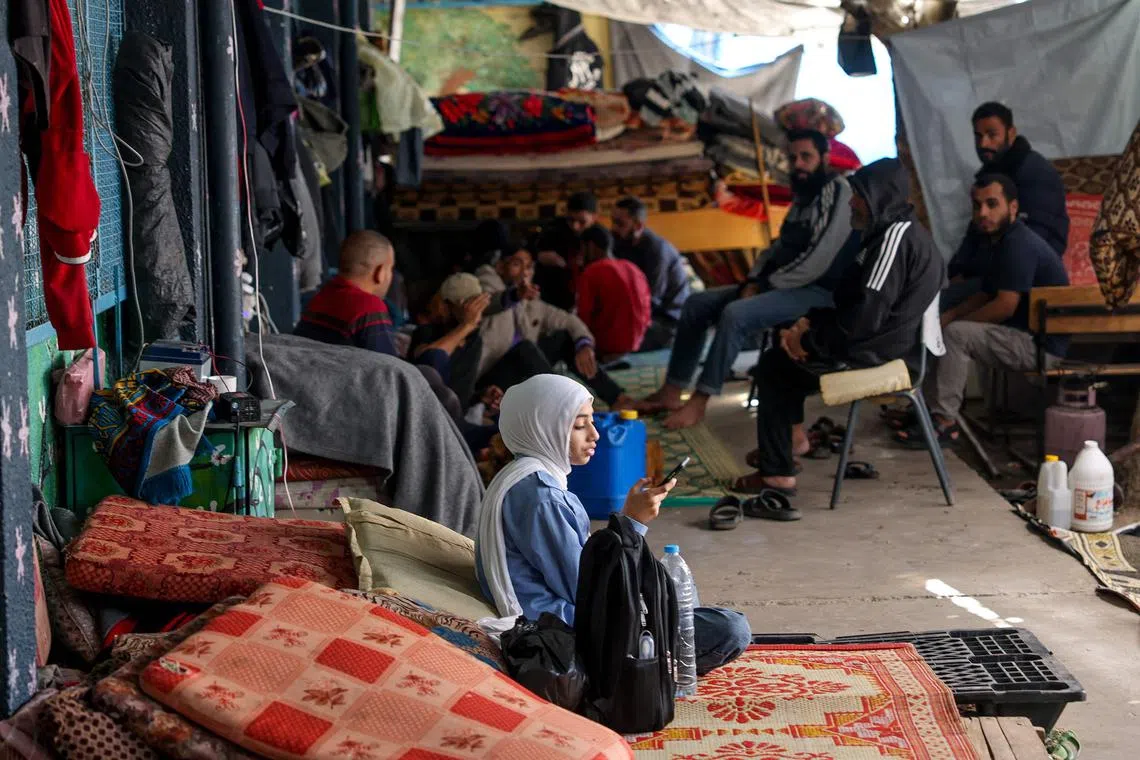 Displaced Palestinians take shelter in a UN school in Bureij in the central Gaza Strip.