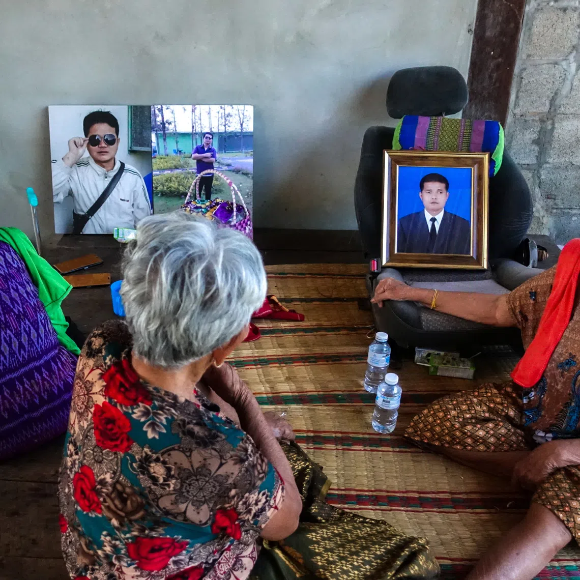 On Rinthalak, 80, mother and relatives of deceased Thai hostage Sudthisak Rinthalak, who was kidnapped to Gaza in the deadly October 7, 2023, attack by Hamas, sit next to his pictures at their house in Nong Khai province, Thailand, December 5, 2025. REUTERS/Thomas Suen