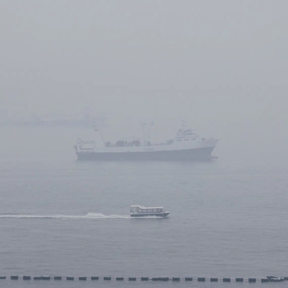 Haze shrouds ships anchored off the southern coast of Singapore, on Oct 14.