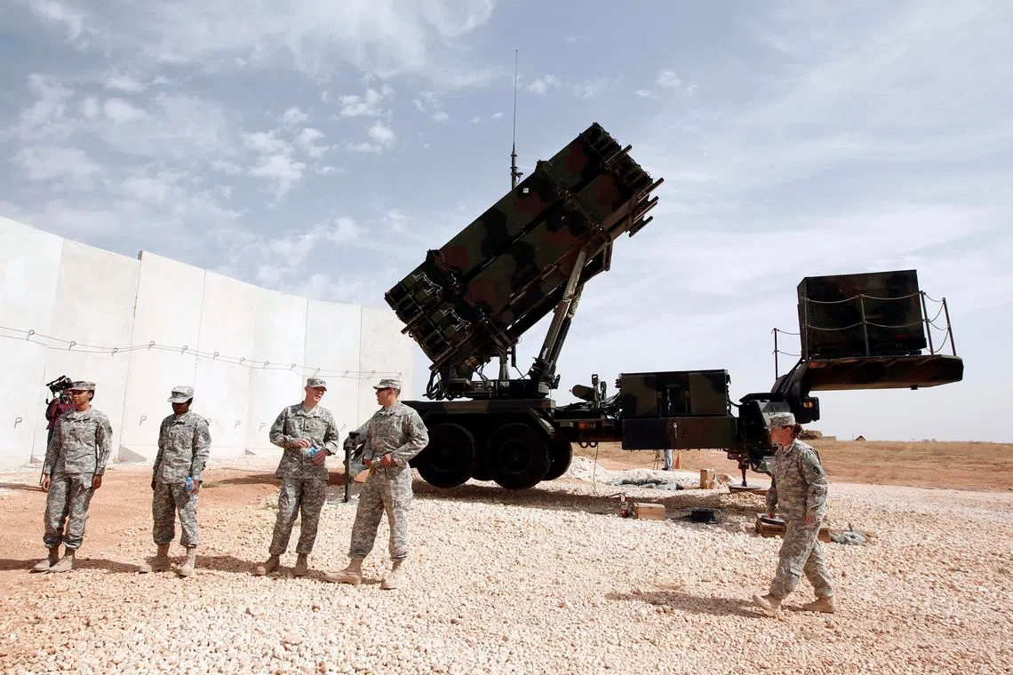 US soldiers stand beside a U.S. Patriot missile system at a Turkish military base in Gaziantep, southeastern Turkey, October 10, 2014. NATO Secretary-General Jens Stoltenberg of Norway is expected to visit U.S. patriot troops in Gaziantep later in the day.