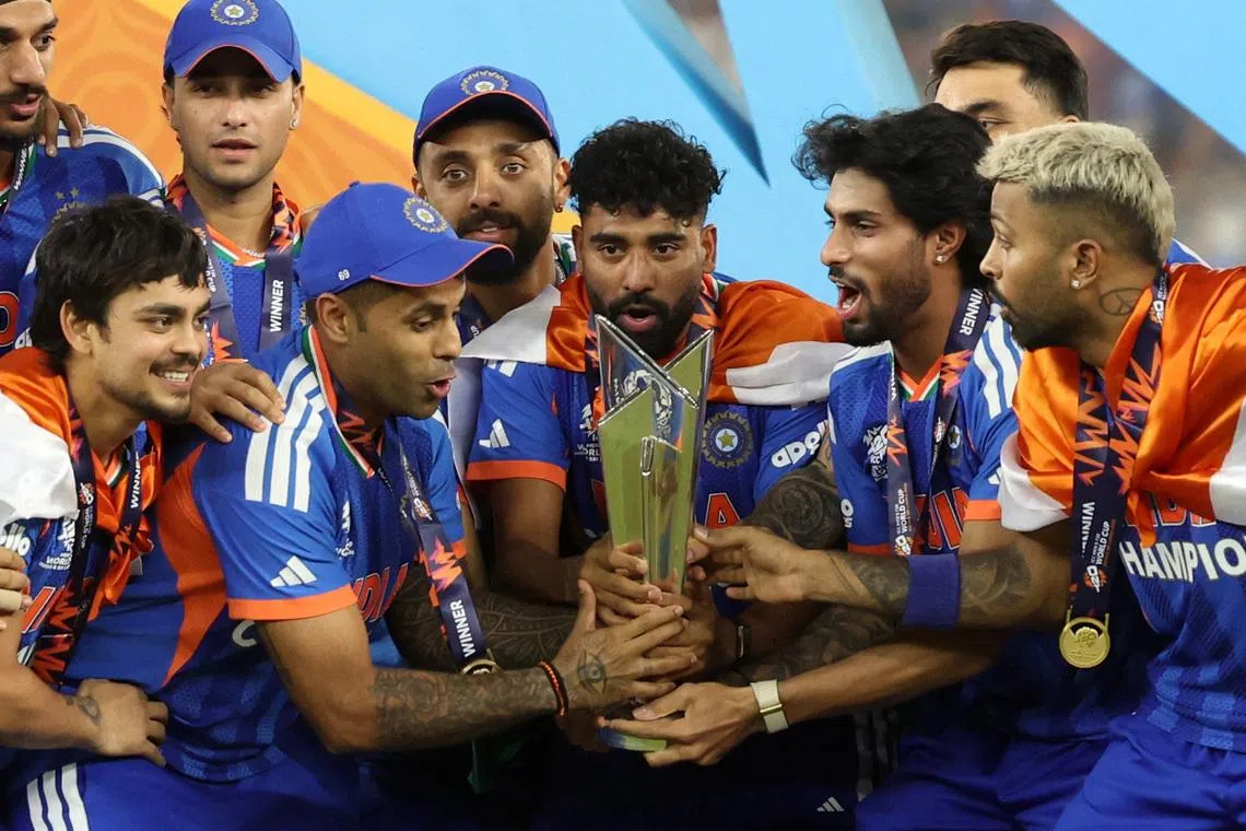 Cricket - ICC Men's T20 World Cup 2026 - Final - India v New Zealand - Narendra Modi Stadium, Ahmedabad, India - March 8, 2026 India's Suryakumar Yadav lifts the trophy with teammates as they celebrate after winning the ICC Men's T20 World Cup REUTERS/Amit Dave