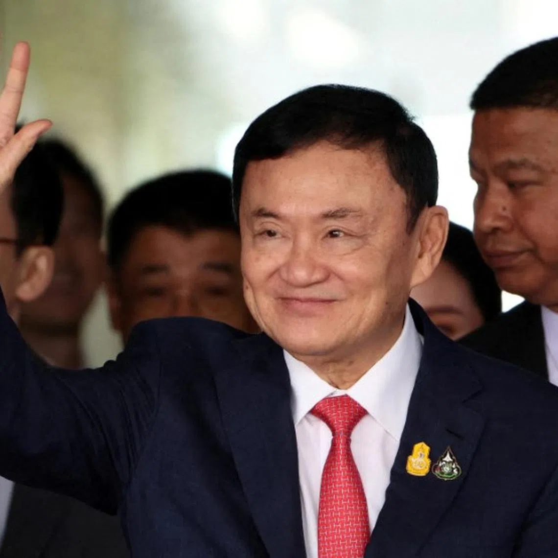 FILE PHOTO: Former Thai Prime Minister Thaksin Shinawatra, who is expected to be arrested upon his return as he ends almost two decades of self-imposed exile, waves at Don Mueang airport in Bangkok, Thailand August 22, 2023. REUTERS/Athit Perawongmetha/File Photo