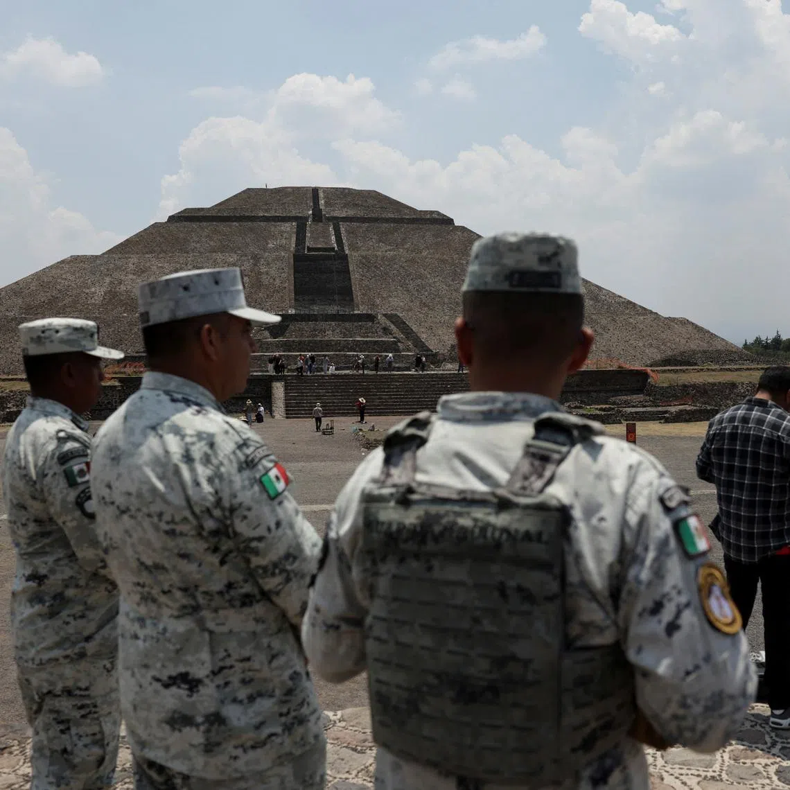 Members of the National Guard stand near the Sun Pyramid, as the Teotihuacan pyramids reopen after being closed following an incident in which a gunman killed a Canadian woman and wounded several others before killing himself, according to authorities, in San Martin de las Piramides, on the outskirts of Mexico City, Mexico, April 22, 2026. Climbing the Moon pyramid remains suspended following the incident at the Teotihuacan pyramids, one of the country's most visited tourist sites. REUTERS/Henry Romero
