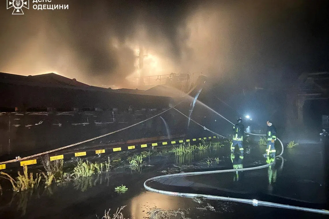 FILE PHOTO: Firefighters extinguish a burning cargo vessel damaged during Russian overnight drone and missile strikes, amid Russia's attack on Ukraine, at a port in Odesa region, Ukraine, in this handout picture released December 23, 2025. Press service of the State Emergency Service of Ukraine in Odesa egion/Handout via REUTERS/ File Photo