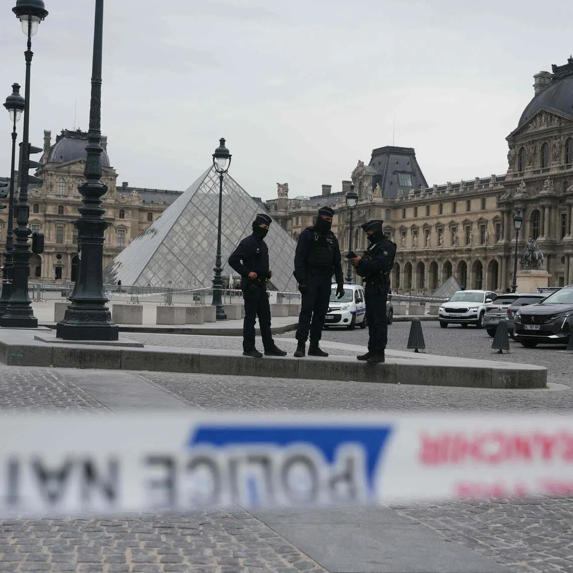 French police officers patrol in front of the Louvre Museum after it was robbed on Oct 19.