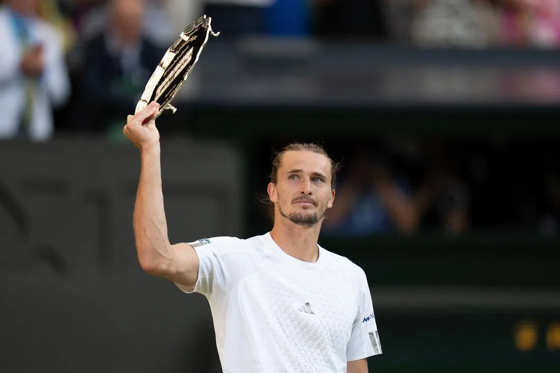 Jul 12, 2026; London, United Kingdom; Alexander Zverev of Germany holds up the finalist trophy after the men’s singles final against Jannik Sinner of Italy on day 14 at All England Lawn Tennis and Croquet Club.  Mandatory Credit: Susan Mullane-Imagn Images