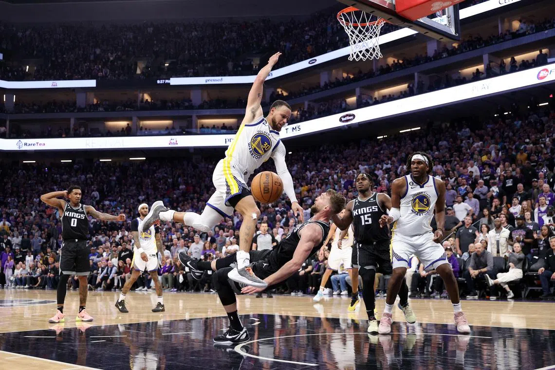 Stephen Curry of the Golden State Warriors is fouled by Domantas Sabonis of the Sacramento Kings in the second half of Game 2 of their NBA play-offs.