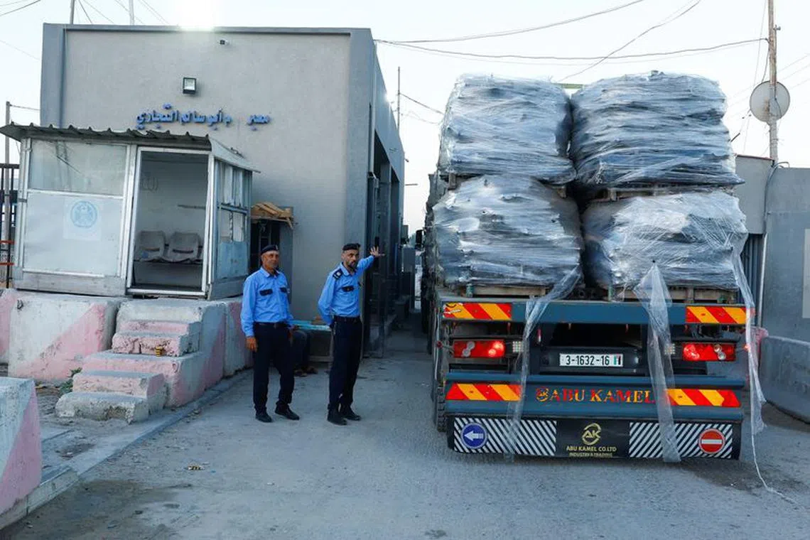 Palestinian police officers walk at the commercial crossing of Kerem Shalom, as Israel ends a ban on exports from Gaza, in Rafah in the southern Gaza Strip September 10, 2023. REUTERS/Ibraheem Abu Mustafa/File Photo