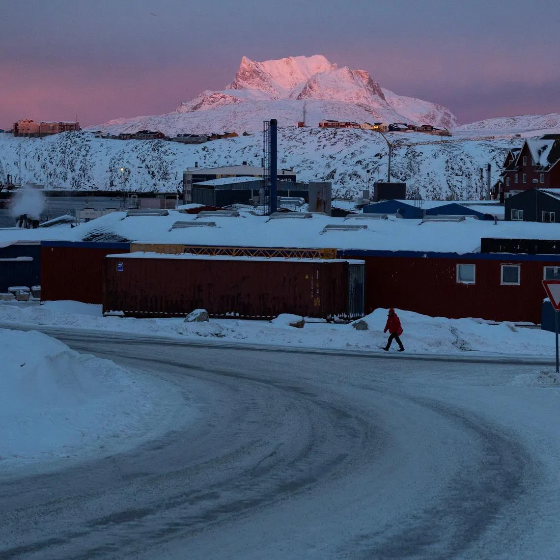A person walks along a street as the sun sets near the U.S. Consulate in Nuuk, Greenland, January 21, 2026. REUTERS/Marko Djurica