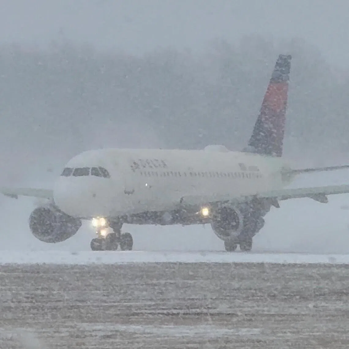 A plane prepares to take off during a winter storm at Greater Rochester International Airport in Rochester, New York.
