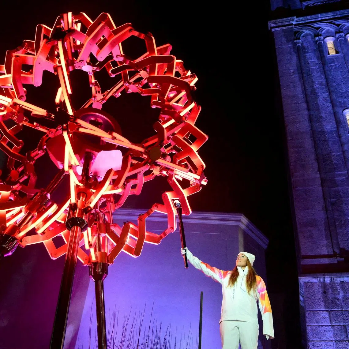 FILE PHOTO: Milano Cortina 2026 Olympics - Opening Ceremony - Cortina d'Ampezzo, Cortina d'Ampezzo, Italy - February 6, 2026 General view as Sofia Goggia of Italy holds the Olympic torch after lighting the Olympic cauldron during the opening ceremony Pool via REUTERS/Stefano Rellandini/File Photo