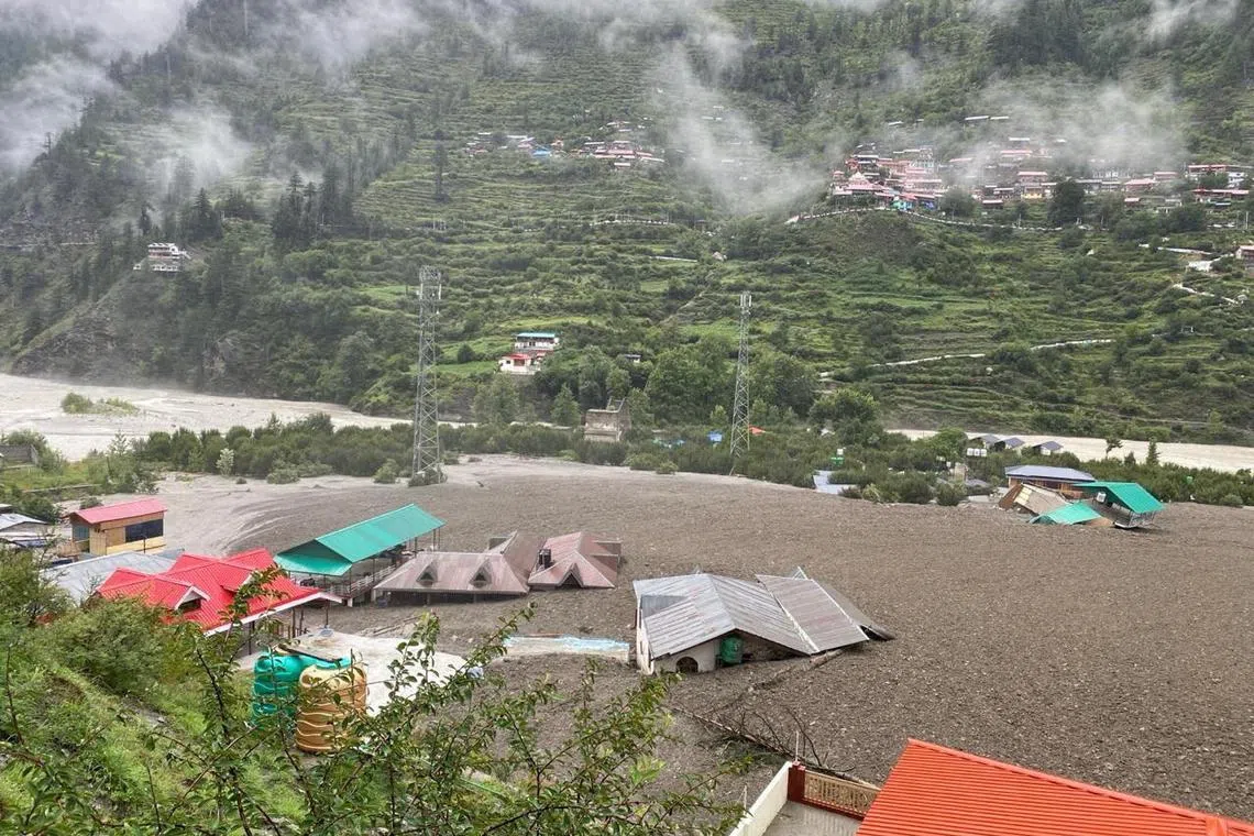 Houses are partially buried by a mudslide, amid flash floods, in Dharali, Uttarakhand, India.