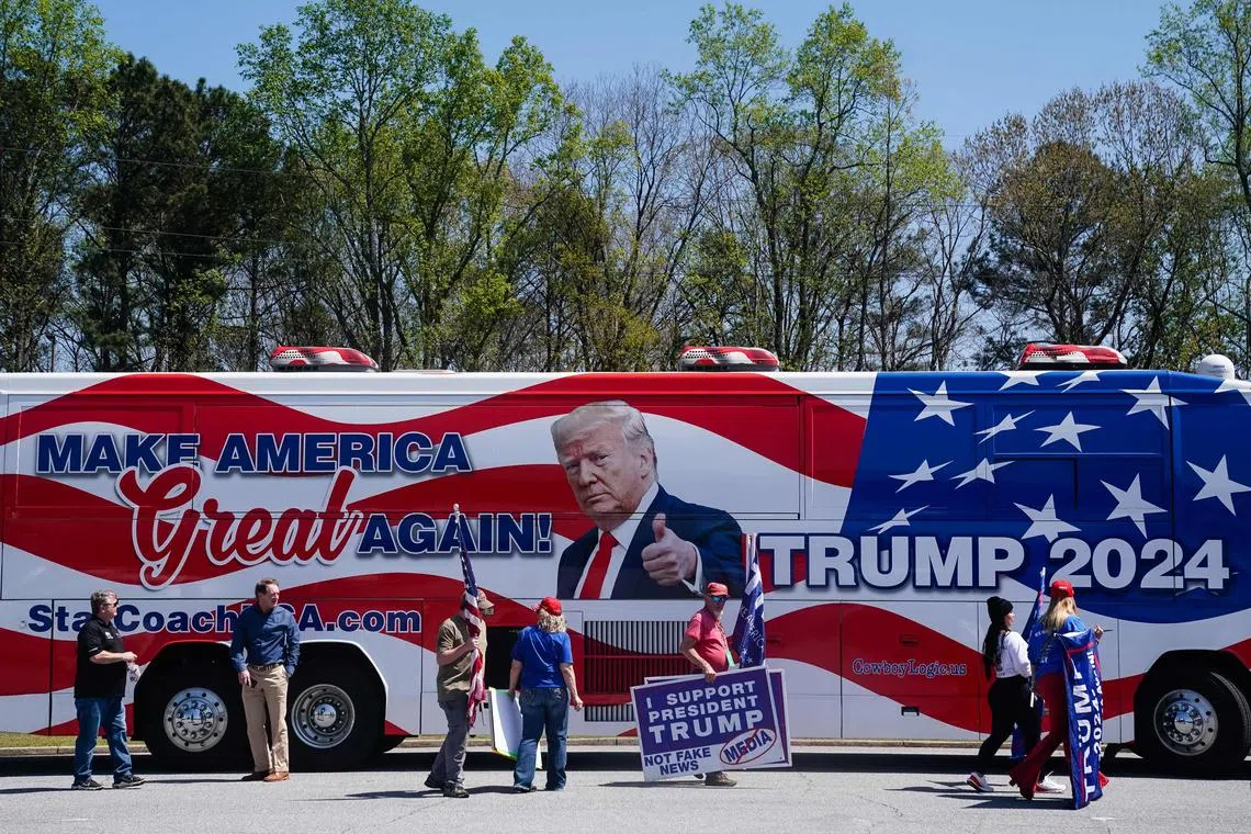 Supporters of former US president Donald Trump are seen outside a stop  on Florida Governor Ron DeSantis' nationwide book tour at Adventure Outdoors, the largest gun store in the country, on March 30, 2023 in Smyrna, Georgia. - DeSantis is widely expected to enter the race for the Republican presidential nomination. (Photo by Elijah Nouvelage / AFP)