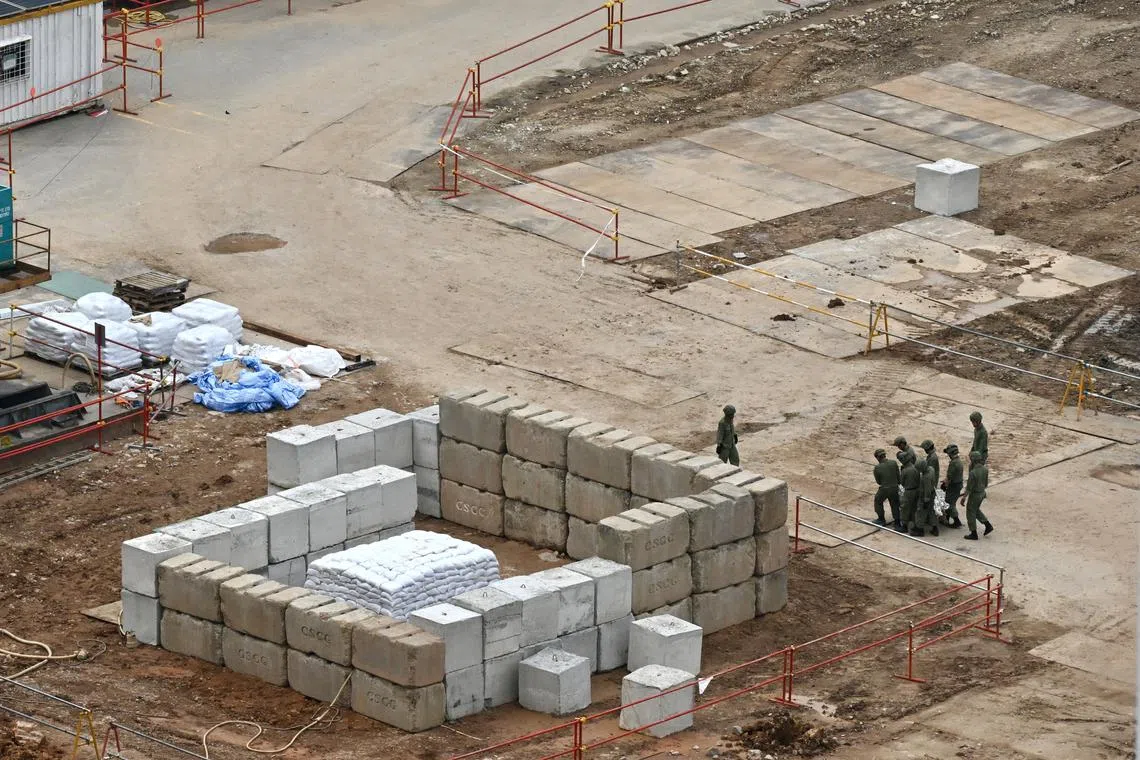 SAF personnel moving the bomb to the concrete block area on Sept 26.