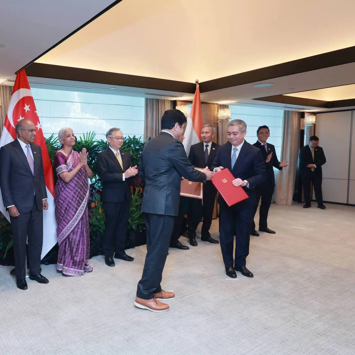 Singapore Deputy Prime Minister Gan Kim Yong (fifth from left), Indian Minister of Finance and Corporate Affairs Nirmala Sitharaman (fourth from left) and ministers from both countries witnessing the exchange of an MOU signed during the fourth India-Singapore Ministerial Roundtable on Aug 20.