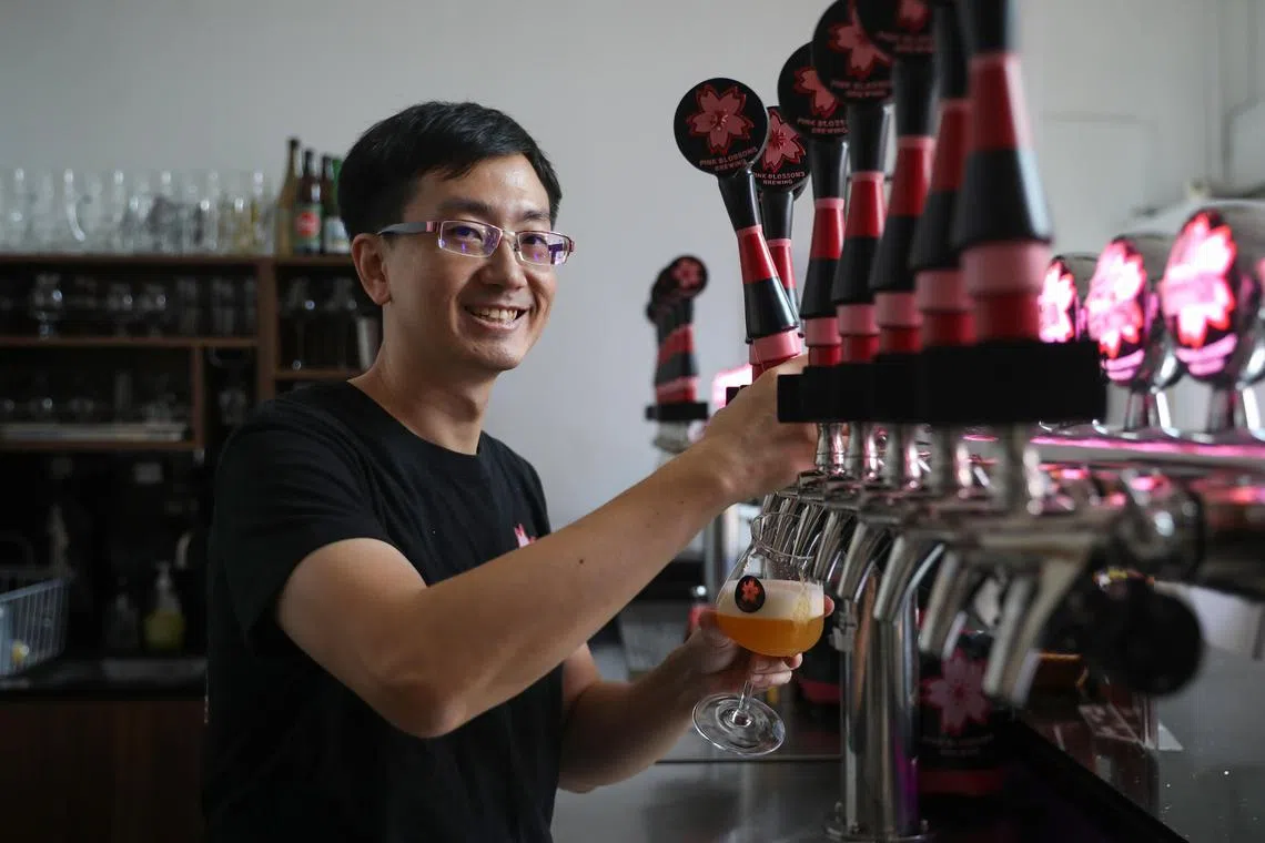 ST20250425_202562600771/elbeer/Taryn Ng// Mr Teo Hong Han, founder and head brewer of Pink Blossoms Brewing, pictured pouring a cup of beer at his brewery on April 25, 2025. He created two general elections themed beers named "Elections Endgame" which is reddish in colour and "A New Hope", which has a golden colour. ST PHOTO: TARYN NG