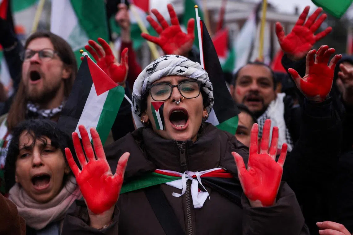 Pro-Palestinian protesters rally near the International Court of Justice in the Netherlands, ahead of the decision.     