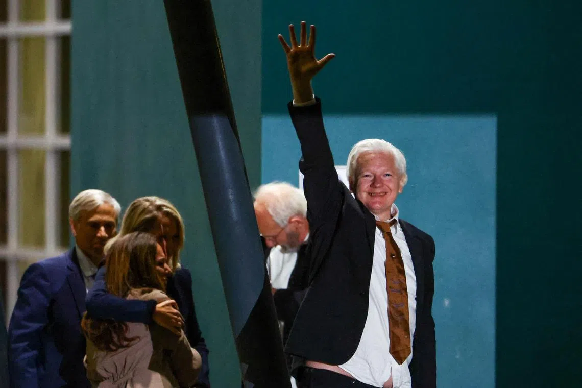 WikiLeaks founder Julian Assange waves as he arrives in Canberra, Australia.