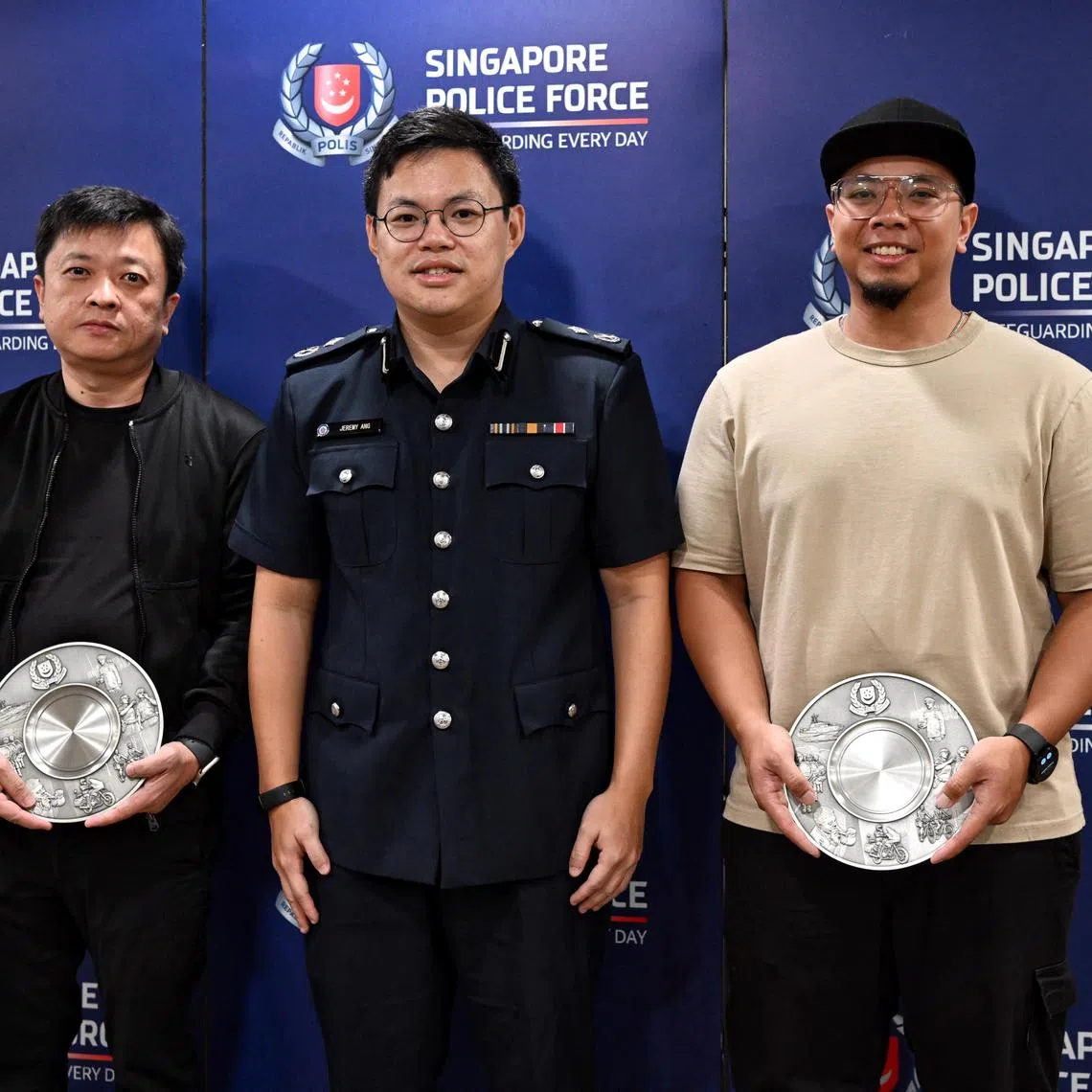 ST20230427_202394376646 Kua Chee Siong/ jlaward27/ 
Commander of Central Police Division, Assistant Commissioner of Police (AC), Jeremy Ang presenting the public spiritedness award to Mr Tan Tjoa Teng (left) and Mr Muhammed Shahadan Bin Sharom (right) at the Police Cantonment Complex on April 27, 2023. 
A man who stepped forward to stop a fight involving an axe-wielding man, as well as another man who managed to save a victim from suicide, will be awarded the Public Spiritedness Award (PSA) this Thursday.