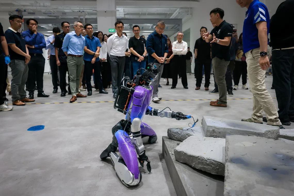A humanoid robot is demonstrated in a mock post-blast investigation during the official opening of the Home Team Humanoid Robotics Centre.