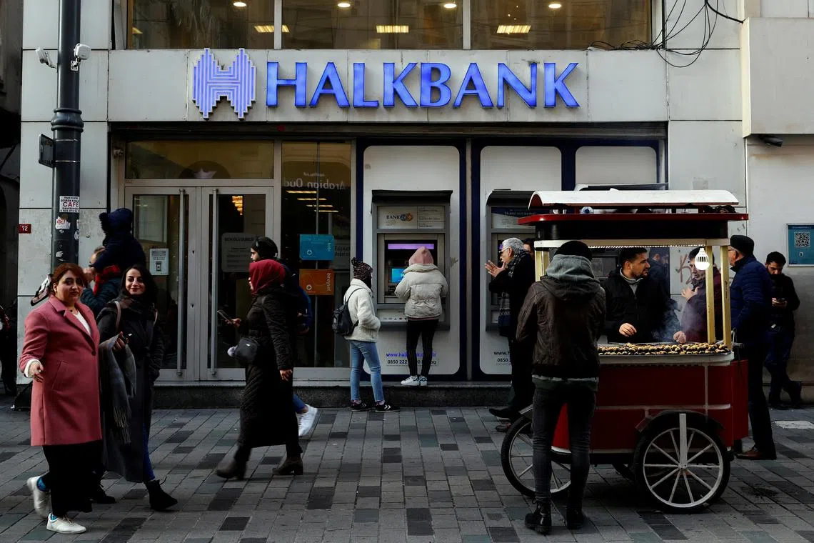 FILE PHOTO: People walk past a branch of Halkbank in central Istanbul, Turkey, January 22, 2020. REUTERS/Murad Sezer/File Photo