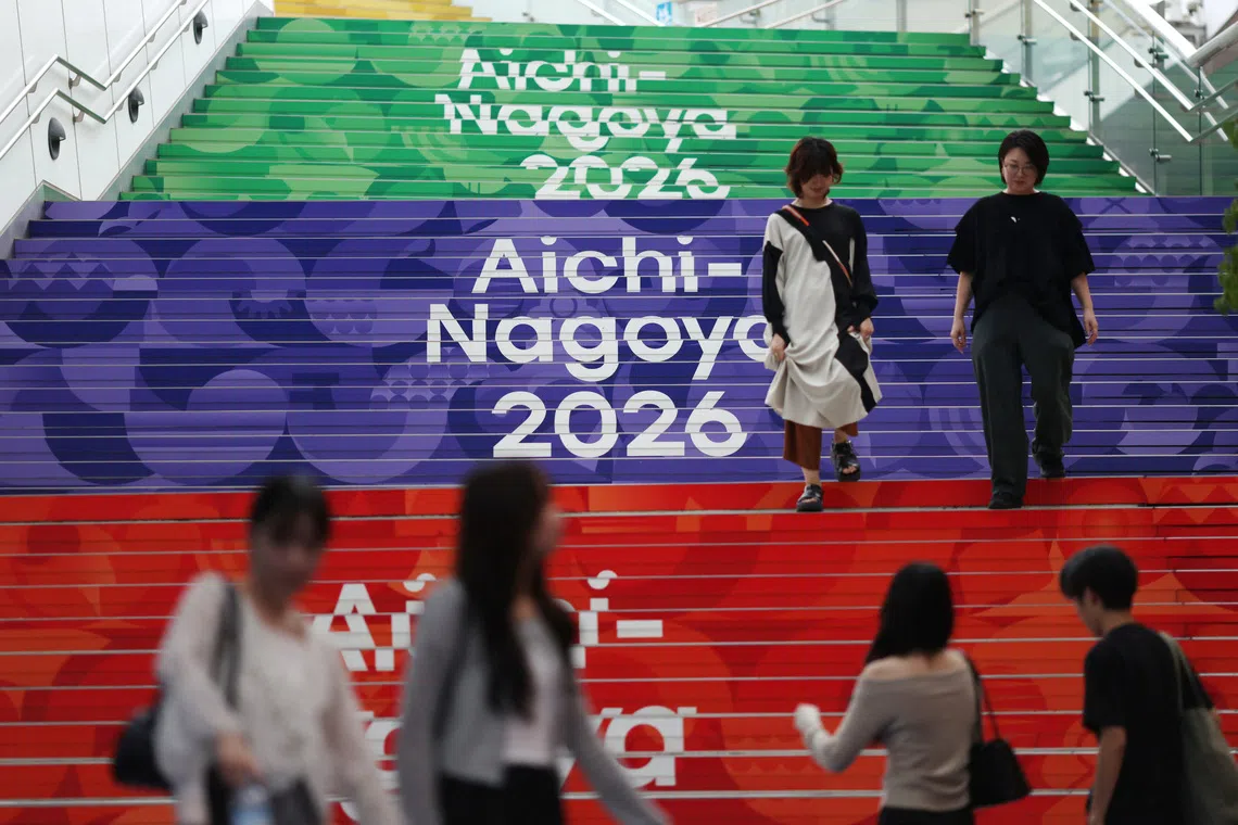 People walk past Asian Games signages in Nagoya, Japan September 14, 2026. REUTERS/Edgar Su