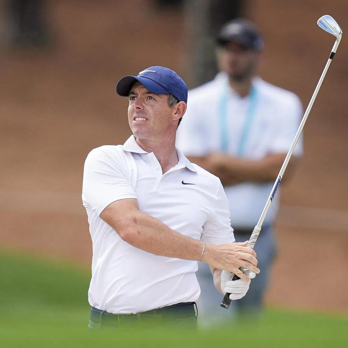 Rory McIlroy watches his approach to five green during a practice round for the PGA Championship.
